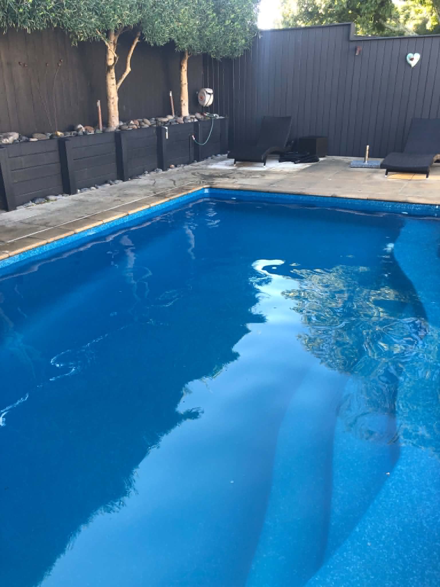 Sparkling, crystal clear swimming pool. Actual results of using Dazzle one-shot pool treatment product